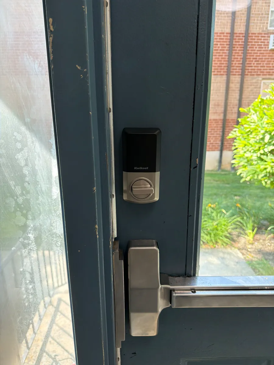 Blue storefront door with a keypad deadbolt above a push bar